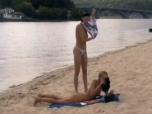 Slim bare virgins frolicking badminton on a sea beach.